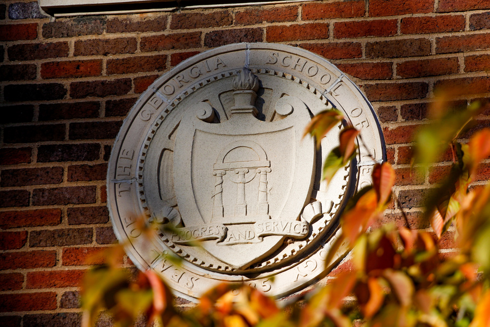 Tech seal on a brick building on campus