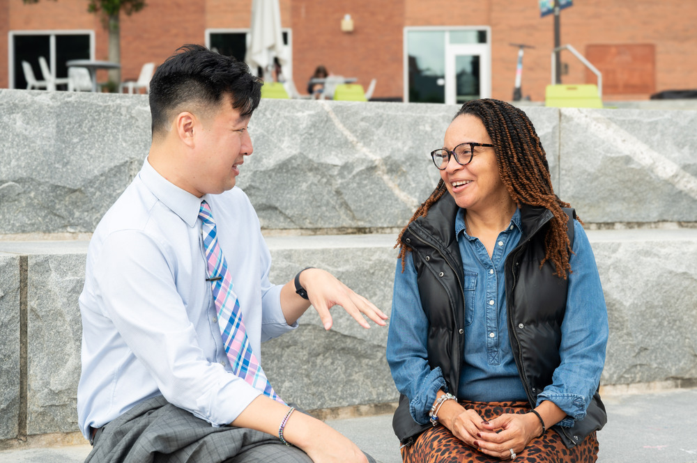 two staff members chatting outside on Tech campus