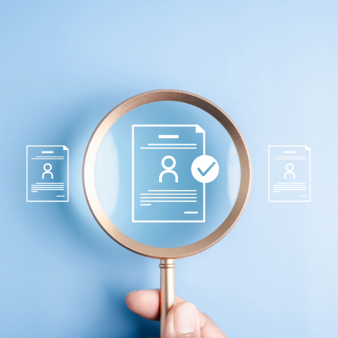 Magnifying glass atop a personnel graphic
